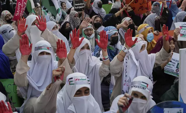 Supporters of the Pakistani religious group "Jamaat-e-Islami" take part in a rally against Israeli airstrikes and to show solidarity with Palestinian people living in Gaza, in Lahore, Pakistan Friday, April 11, 2025. (AP Photo/K.M. Chaudary)