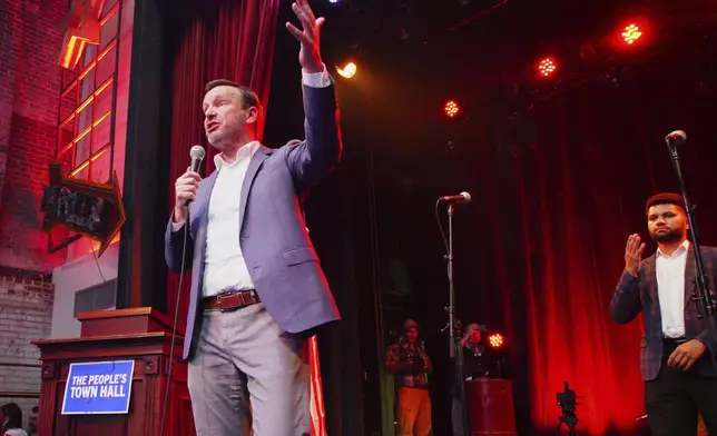Sen. Chris Murphy, D-Conn., speaks from the stage of the Haw River Ball Room during a town hall in Saxapahaw, N.C., Thursday, April 24, 2025, as Rep. Maxwell Frost, D-Fla., right, listens. (AP Photo/Allen G. Breed)