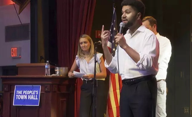 Rep. Maxwell Frost, D-Fla., speaks from the stage of the Haw River Ball Room during a town hall in Saxapahaw, N.C., Thursday, April 24, 2025. (AP Photo/Allen G. Breed)