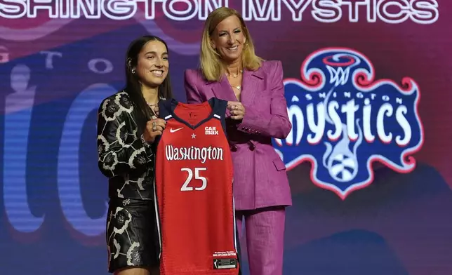 Kentucky's Georgia Amoore, left, poses for a photo with WNBA commissioner Cathy Engelbert after being selected sixth overall by the Washington Mystics during the first round of the WNBA basketball draft, Monday, April 14, 2025, in New York. (AP Photo/Pamela Smith)