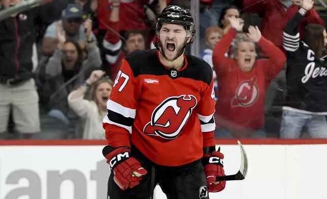 New Jersey Devils center Paul Cotter reacts after his goal, which was disallowed, against Minnesota Wild goaltender Filip Gustavsson, during the first overtime of an NHL hockey game, Monday, March 31, 2025, in Newark, N.J. (AP Photo/Julia Demaree Nikhinson)