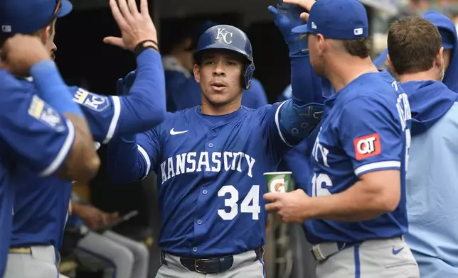 Kansas City Royals' Freddy Fermin (34) is congratulated after hitting a home run off Detroit Tigers starting pitcher Casey Mize during the seventh inning of a baseball game, Saturday, April 19, 2025, in Detroit. (AP Photo/Jose Juarez)