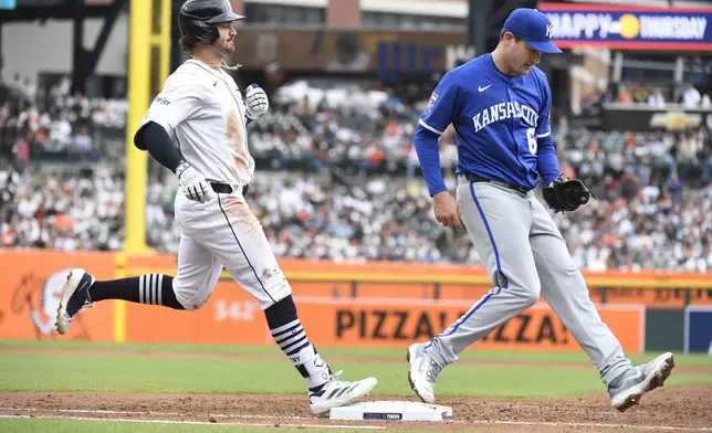 Kansas City Royals starting pitcher Seth Lugo, right, tags first base to force out Detroit Tigers' Zach McKinstry during the third inning of a baseball game, Saturday, April 19, 2025, in Detroit. (AP Photo/Jose Juarez)