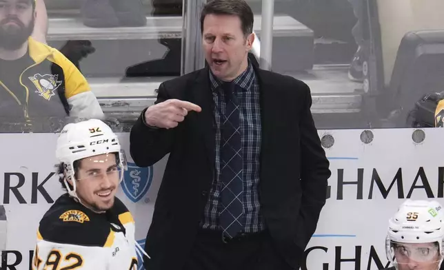 Boston Bruins interim head coach Joe Sacco gives instructions from behind his bench during the third period of an NHL hockey game against the Pittsburgh Penguins in Pittsburgh, Sunday, April 13, 2025. (AP Photo/Gene J. Puskar)