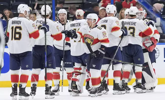 Florida Panthers players celebrate after defeating the against the Tampa Bay Lightning during Game 1 of an NHL hockey Stanley Cup first-round playoff series, Tuesday, April 22, 2025, in Tampa, Fla. (AP Photo/Chris O'Meara)