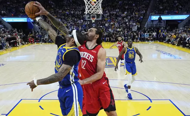 Houston Rockets center Steven Adams (12) blocks a shot by Golden State Warriors guard Gary Payton II (0) during the second half of an NBA basketball game Sunday, April 6, 2025, in San Francisco. (AP Photo/Godofredo A. Vásquez)