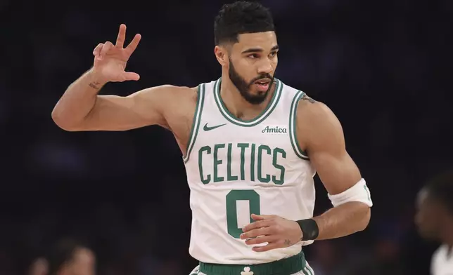 Boston Celtics' Jayson Tatum reacts after scoring a three point basket during the first half of an NBA basketball game against the New York Knicks, Tuesday, April 8, 2025, in New York. (AP Photo/Pamela Smith)