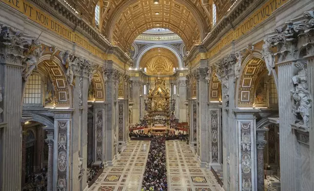 People line up to pay their respects to Pope Francis lying in state, inside St. Peter's Basilica, at the Vatican, Friday, April 25, 2025. (AP Photo/Andrew Medichini)