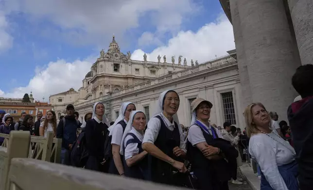Nuns wait in line to view Pope Francis lying in state inside St. Peter's Basilica, at the Vatican, Friday, April 25, 2025. (AP Photo/Gregorio Borgia)