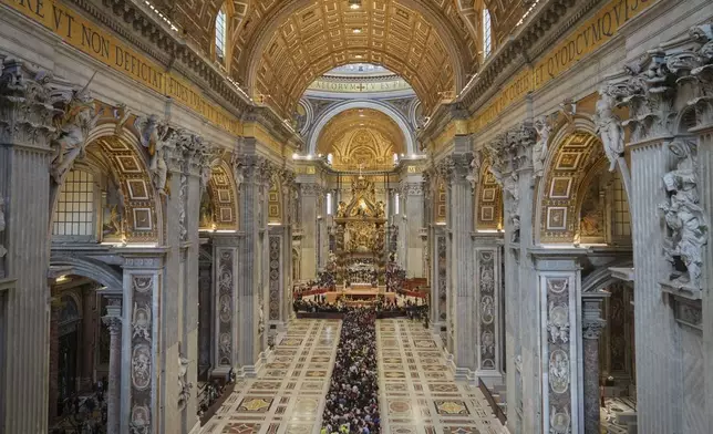 People line up to pay their respects to Pope Francis lying in state, inside St. Peter's Basilica, at the Vatican, Friday, April 25, 2025. (AP Photo/Andrew Medichini)