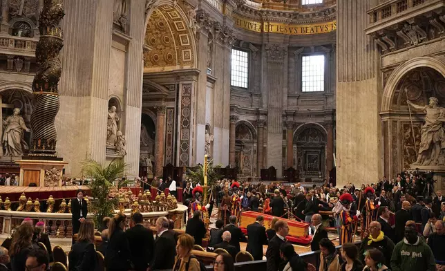 People pay respects to the late Pope Francis, lying in state at St. Peter's Basilica for the final day, at the Vatican, Friday, April 25, 2025. (AP Photo/Andreea Alexandru)