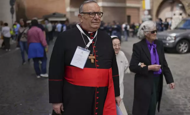 Cardinal Francesco Montenegro walks at the Vatican, Friday, April 25, 2025. (AP Photo/Francisco Seco)