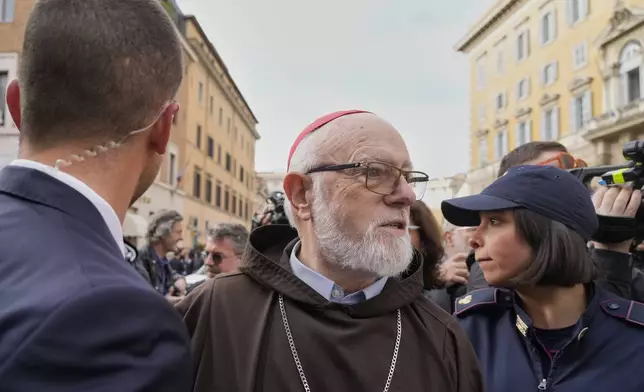 Security and police make way for Cardinal Sean O'Malley arriving for a college of cardinals' meeting, at the Vatican, Friday, April 25, 2025. (AP Photo/Gregorio Borgia)