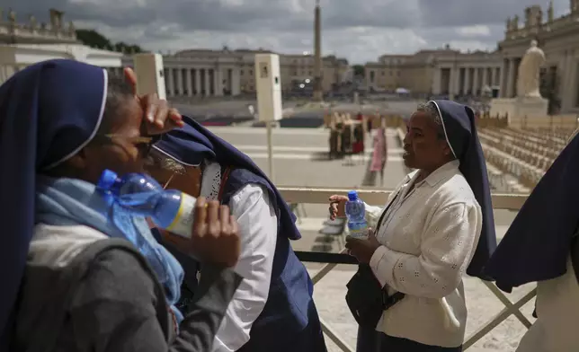 Nuns leave after viewing Pope Francis lying in state inside St. Peter's Basilica, at the Vatican, Friday, April 25, 2025. (AP Photo/Andrew Medichini)