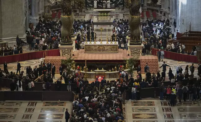 People line up to pay their respects to Pope Francis lying in state, inside St. Peter's Basilica, at the Vatican, Friday, April 25, 2025. (AP Photo/Andrew Medichini)