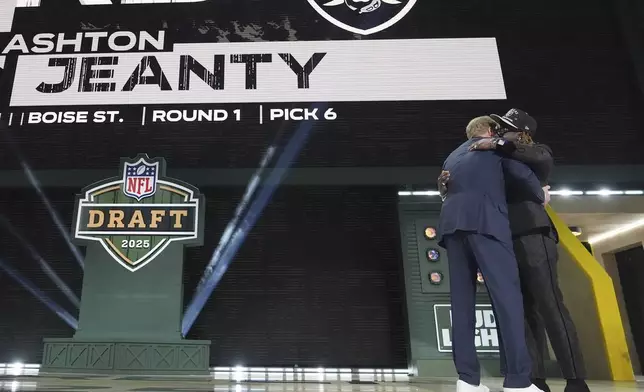 Boise State running back Ashton Jeanty, right, embraces NFL Commissioner Roger Goodell after being chosen by the Las Vegas Raiders with the sixth overall pick during the first round of the NFL football draft, Thursday, April 24, 2025, in Green Bay, Wis. (AP Photo/Jeff Roberson)