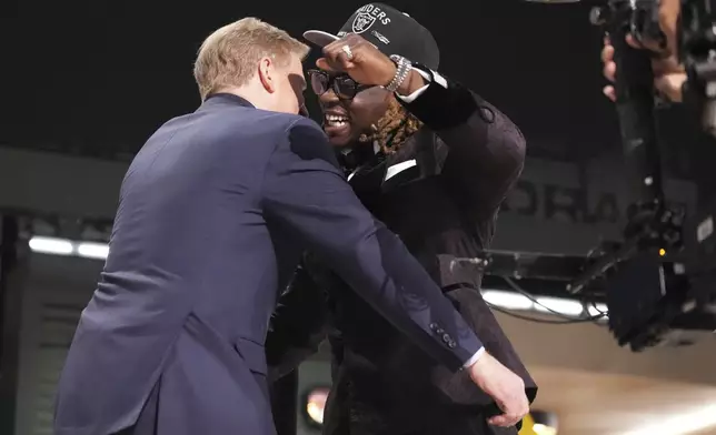 Boise State running back Ashton Jeanty, right, embraces NFL Commissioner Roger Goodell after being chosen by the Las Vegas Raiders with the sixth overall pick during the first round of the NFL football draft, Thursday, April 24, 2025, in Green Bay, Wis. (AP Photo/Jeff Roberson)
