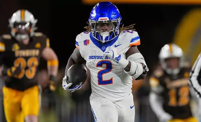 FILE - Boise State running back Ashton Jeanty (2) carries the ball in the first half of an NCAA college football game Saturday, Nov. 23, 2024, in Laramie, Wyo. (AP Photo/David Zalubowski, File)