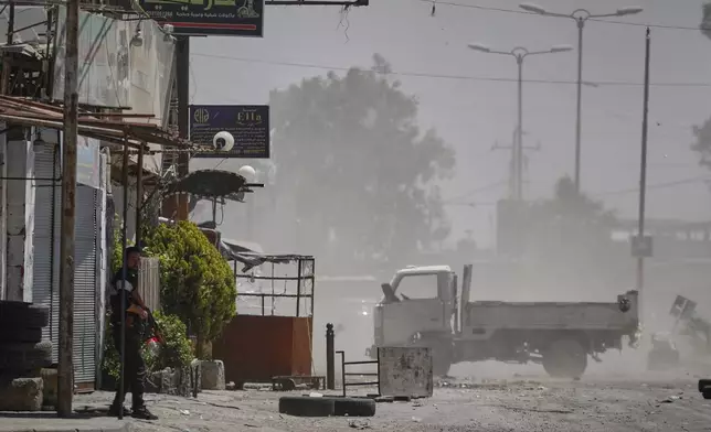 A Druze gunmen stands guard near a checkpoint a day after clashes between members of the minority Druze sect and pro-government fighters left at least four people dead in the southern suburb of Jaramana, Damascus, Syria, Tuesday, April 29, 2025. (AP Photo/Omar Sanadiki)