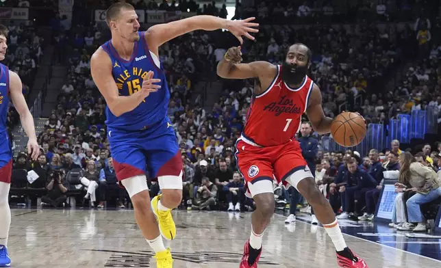 Los Angeles Clippers guard James Harden, right, drives past Denver Nuggets center Nikola Jokic (15) in the second half of Game 1 of an NBA first-round playoff series Saturday, April 19, 2025, in Denver. (AP Photo/David Zalubowski)