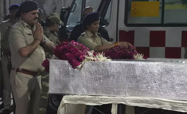 Police officers pay tribute to the victims who were killed by militants near Pahalgam in Indian-controlled Kashmir, after the bodies arrived at an airport in Ahmedabad, India, Wednesday, April 23, 2025. (AP Photo)