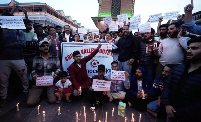 People participate during a candlelight protest after tourists were killed in Srinagar, Indian controlled Kashmir, Wednesday, April. 23, 2025. (AP Photo/Mukhtar Khan)