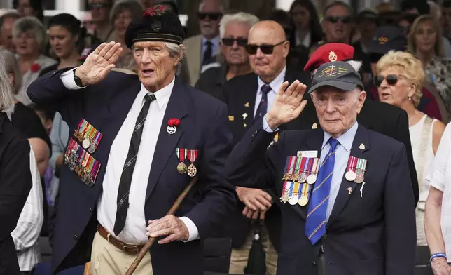 Veterans salute during the Anzac Day commemorations to honor their war dead in Nelson Bay, Australia, Friday, April 25, 2025. (AP Photo/Mark Baker)