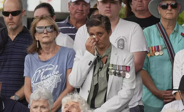 A woman reacts during the Anzac Day commemorations in Nelson Bay, Australia, Friday, April 25, 2025. (AP Photo/Mark Baker)