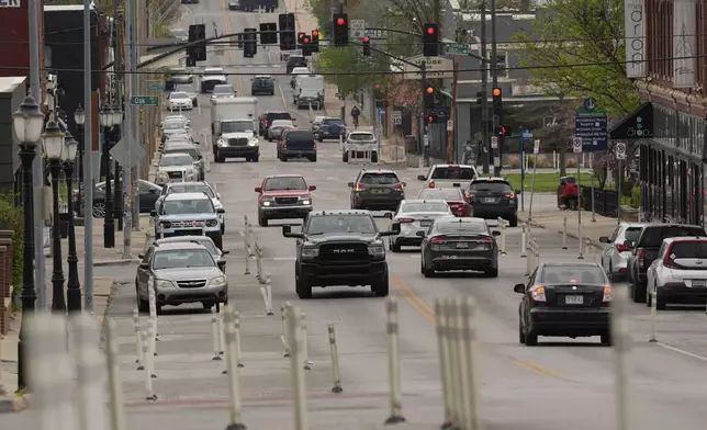 Motorists navigate 31st Street in Kansas City, Mo., where the city implemented a "road diet" reducing the street from four lanes to two in an effort to reduce speeding and accidents, Thursday, April 17, 2025. (AP Photo/Charlie Riedel)