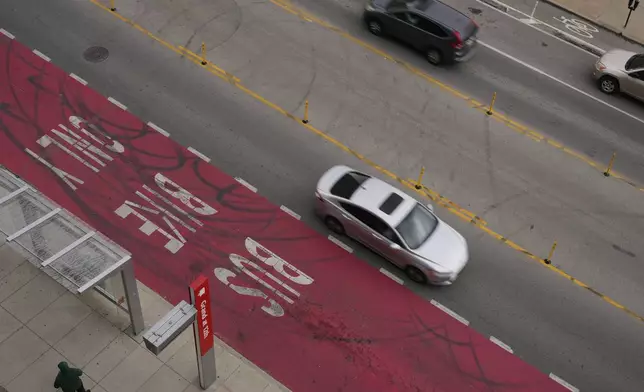 Cars drive on Grand Boulevard in Kansas City, Mo., where the city implemented a "road diet" reducing the street from four lanes to two in an effort to reduce speeding and accidents, Thursday, April 17, 2025. (AP Photo/Charlie Riedel)