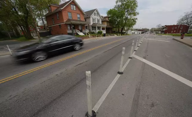 A motorist drives on 31st Street in Kansas City, Mo., where the city implemented a "road diet" reducing the street from four lanes to two in an effort to reduce speeding and accidents, Thursday, April 17, 2025. (AP Photo/Charlie Riedel)