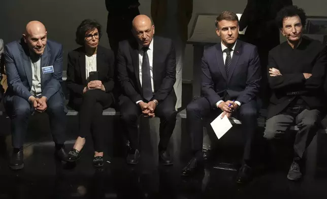 French President Emmanuel Macron, second right, IMA director Jack Lang, right, Palestinian film director Rashid Masharawi, left, French Culture minister Rachida Dati and Hani al-Hayek, center, the Palestinian Authority's minister for heritage and tourism listen as they visit the exhibition "Treasures rescued from Gaza" Monday, April 14, 2025 at the Arab World Institute (IMA) in Paris. (AP Photo/Michel Euler, Pool)