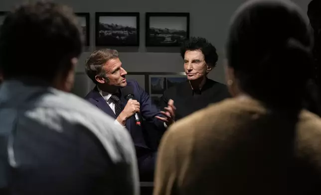 French President Emmanuel Macron, left, speaks as IMA director Jack Lang listens during their visit at the exhibition "Treasures rescued from Gaza" Monday, April 14, 2025 at the Arab World Institute (IMA) in Paris. (AP Photo/Michel Euler, Pool)