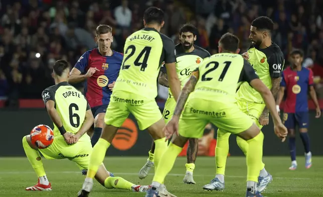 Barcelona's Dani Olmo, second left, scores his side's opening goal during a Spanish La Liga soccer match between Barcelona and Mallorca at the Lluis Companys Olympic stadium in Barcelona, Spain, Tuesday, April 22, 2025. (AP Photo/Joan Monfort)