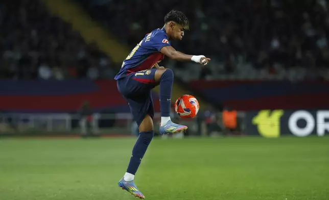 Barcelona's Lamine Yamal controls the ball during a Spanish La Liga soccer match between Barcelona and Mallorca at the Lluis Companys Olympic stadium in Barcelona, Spain, Tuesday, April 22, 2025. (AP Photo/Joan Monfort)