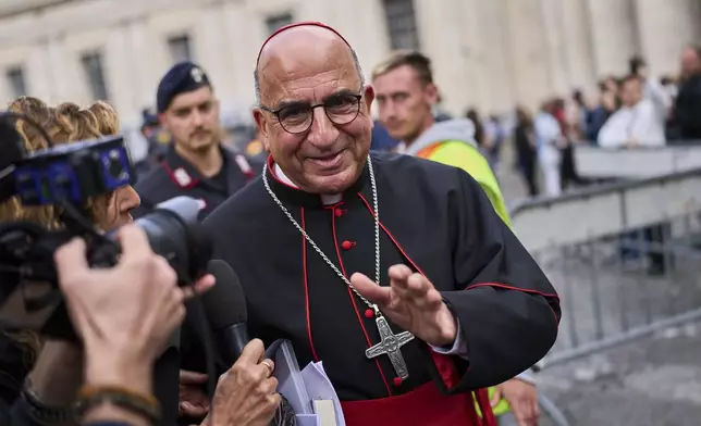 Cardinal Fernando Natalio Chomalí Garib speaks to the media in St. Peter's Square, at the Vatican, Thursday, April 24, 2025. (AP Photo/Bernat Armangue)