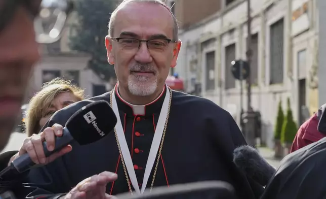 Cardinal Pierbattista Pizzaballa is approached by reporters as he arrives for a college of cardinals' meeting, at the Vatican, Monday, April 28, 2025. (AP Photo/Gregorio Borgia)