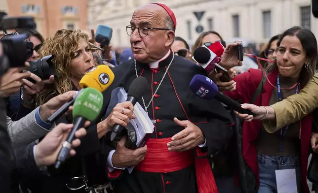 Cardinal Fernando Natalio Chomalí Garib speaks to the media in St. Peter's Square, at the Vatican, Thursday, April 24, 2025. (AP Photo/Bernat Armangue)