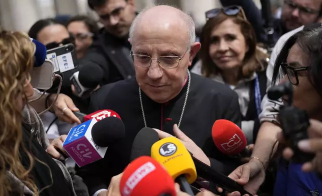 Cardinal Fernando Filoni is approached by reporters as he leaves the college of cardinals' meeting, at the Vatican, Thursday, April 24, 2025. (AP Photo/Bernat Armangue)