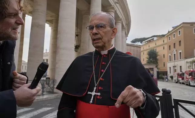 Cardinal Gregorio Rosa Chávez is approached by a reporter as he arrives for a college of cardinals' meeting, at the Vatican, Monday, April 28, 2025. (AP Photo/Gregorio Borgia)