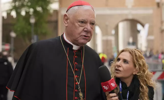 Cardinal Gerhard Ludwig Müller is approached by a reporter as he arrives for a college of cardinals' meeting at the Vatican, Thursday, April 24, 2025. (AP Photo/Markus Schrieber)