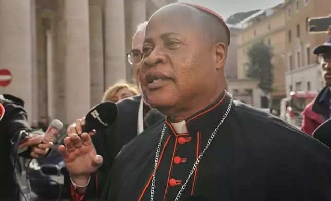 Cardinal Fridolin Ambongo Besungu, followed by Cardinal Pierbattista Pizzaballa, arrive for a college of cardinals' meeting, at the Vatican, Monday, April 28, 2025. (AP Photo/Gregorio Borgia)