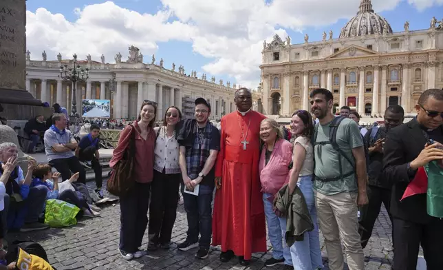Cardinal John Olorunfemi Onaiyekan, of Nigeria, poses for photos with a group after the funeral of Pope Francis in St. Peter's Square at the Vatican, Saturday, April 26, 2025. (AP Photo/Andrew Medichini)