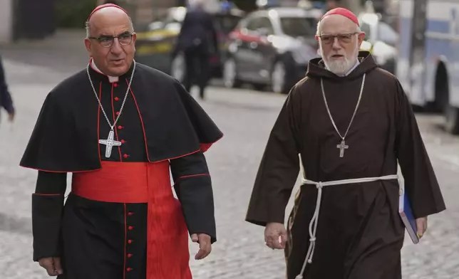 Cardinal Fernando Natalio Chomalí Garib, left, and Cardinal Sean O'Malley, arrive for a college of cardinals' meeting at the Vatican, Thursday, April 24, 2025. (AP Photo/Andrew Medichini)