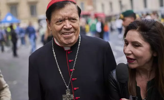 Cardinal Norberto Rivera Carrera is approached by a reporter as he exits the college of cardinals' meeting, at the Vatican, Thursday, April 24, 2025. (AP Photo/Bernat Armangue)