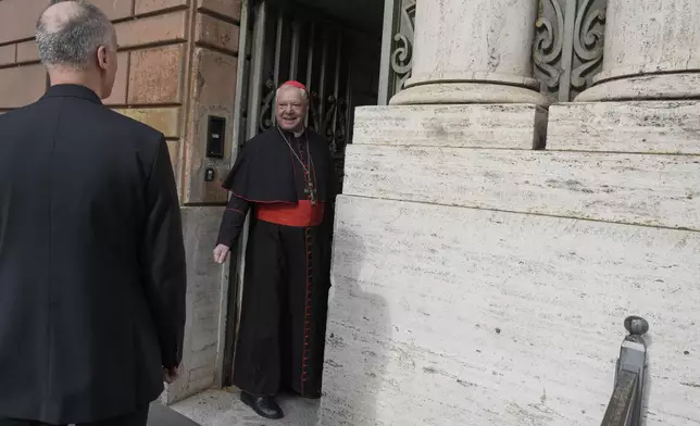 Cardinal Gerhard Ludwig Müller stands in a gateway on his way to a college of cardinals' meeting at the Vatican, Thursday, April 24, 2025. (AP Photo/Markus Schreiber)