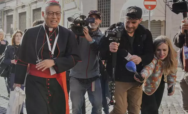 Cardinal Stephen Chow Sau-yan is approached by reporters as he arrives for a college of cardinals' meeting, at the Vatican, Wednesday, April 30, 2025. (AP Photo/Gregorio Borgia)