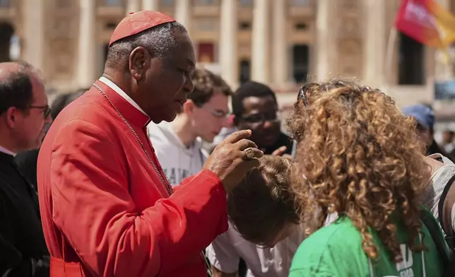 Cardinal John Olorunfemi Onaiyekan, of Nigeria, speaks to people after the funeral of Pope Francis in St. Peter's Square at the Vatican, Saturday, April 26, 2025. (AP Photo/Andreea Alexandru)