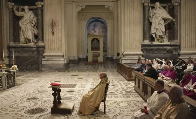 Cardinal Baldassare Reina, center, leads a prayer for Pope Francis, at the St. John Lateran Basilica in Rome, Thursday April 24, 2025. (AP Photo/Francisco Seco)