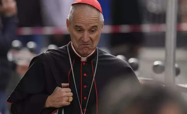 Cardinal Jean-Paul Vesco reacts to a reporter's question as he arrives for a college of cardinals' meeting, at the Vatican, Friday, April 25, 2025. (AP Photo/Gregorio Borgia)